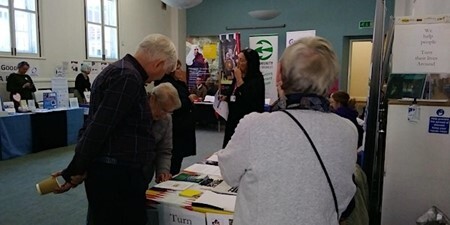 Image of people standing beside tables at 2022 Volunteering Fair