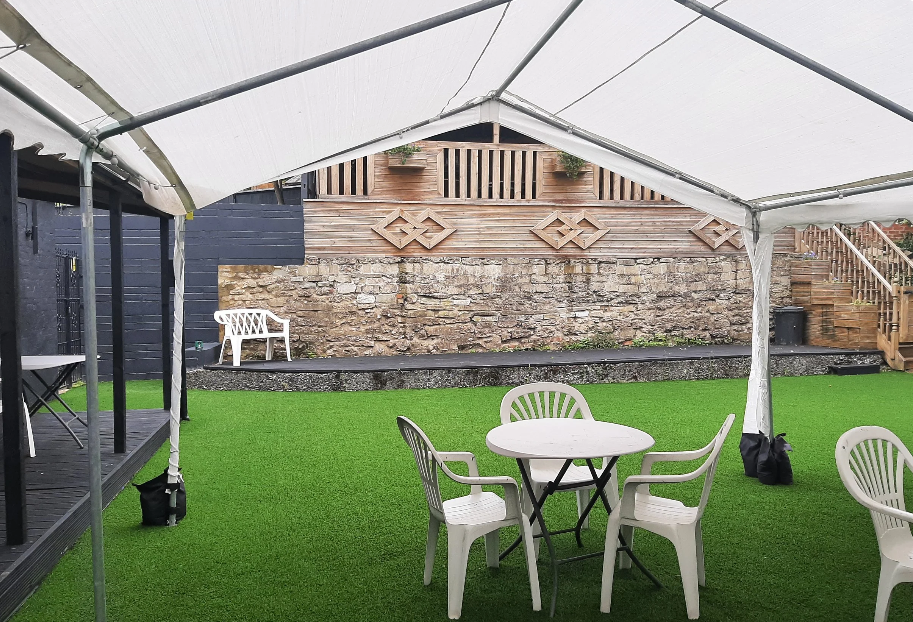 Garden with tables and chairs under gazeebo
