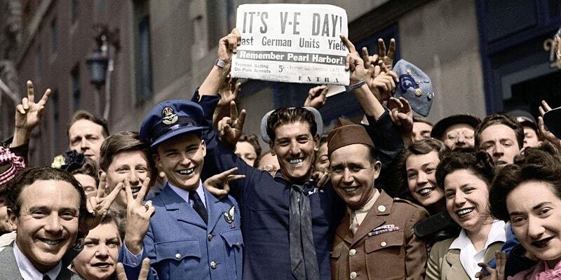 People standing with VE day sign