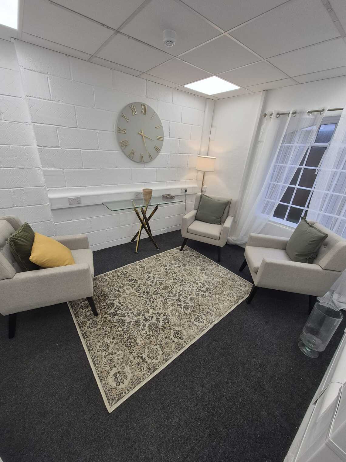 Armchairs facing each other in room with carpeted floor
