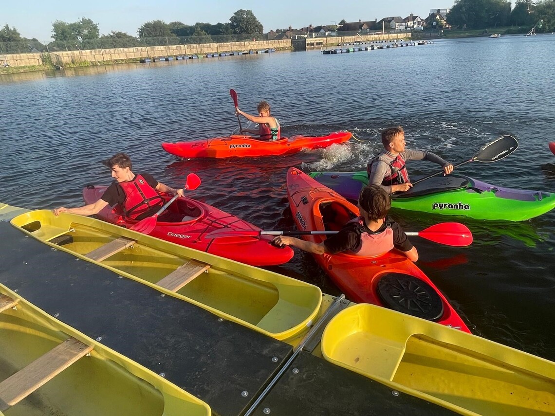 Young people paddling in canoes
